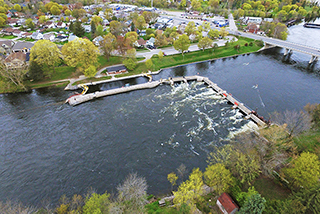 An aerial view of Scotts Mills lock at Trent-Severn Waterway National Historic Site showing dam, lockstation and surrounding neighbourhood.
